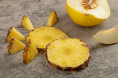 Lezzetli tatlı kavun ve taş zeminde olgun ananas. Yüksek kalite fotoğraf