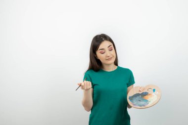 Renkli fırçayla fırça tutan genç kadın ressamın portresi. Yüksek kalite fotoğraf