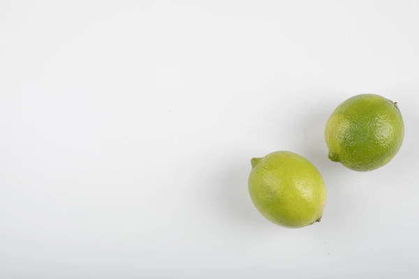 Twee Rijpe Limoenvruchten Geïsoleerd Witte Achtergrond Hoge Kwaliteit Foto — Stockfoto