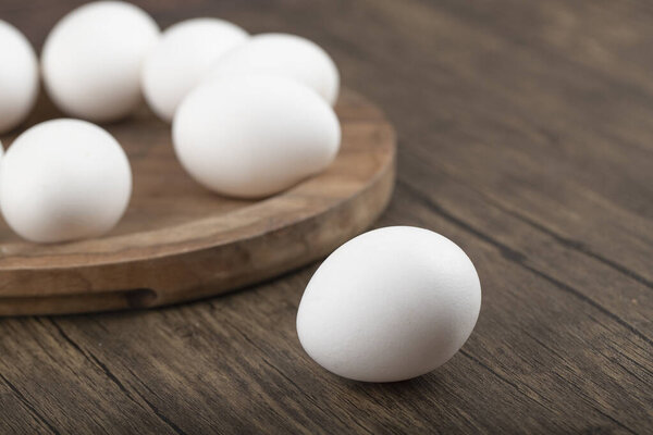 Close up photo of fresh eggs on wooden background. High quality photo
