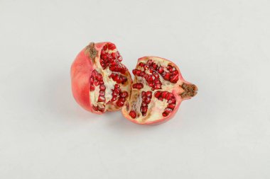 Dilimlenmiş taze olgun nar beyaz masaya konur. Yüksek kalite fotoğraf