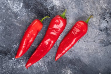 Red fresh chili peppers placed on marble surface. High quality photo