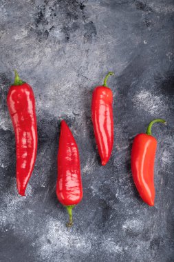 Red fresh chili peppers placed on marble surface. High quality photo