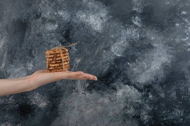 Kadın el ele tutuşma mermer arka planda yulaf ezmeli kurabiye yığını. Yüksek kalite fotoğraf