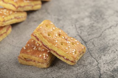 Delicious sweet biscuits decorated with sesame seeds on stone. High quality photo