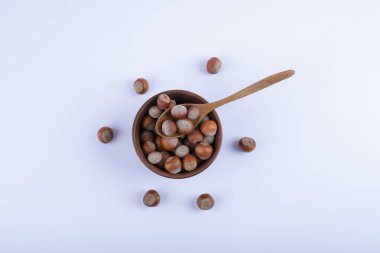 Beyaz arka planda bir kase organik fındık ve kaşık. Yüksek kalite fotoğraf