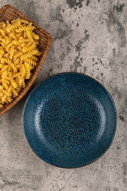 Arka planda pişmemiş bir sepet fusilli makarna. Yüksek kalite fotoğraf
