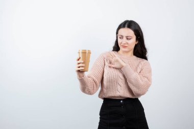 Beyaz duvara içki bardağı tutan güzel bir kızın portresi. Yüksek kalite fotoğraf
