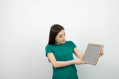 Beyaz duvarın karşısında el ele tutuşmuş güzel bir kadının portresi. Yüksek kalite fotoğraf