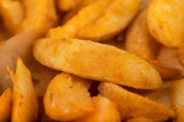 Yakın çekim, kızarmış altın patates kama dokusu arka plan. Yüksek kalite fotoğraf