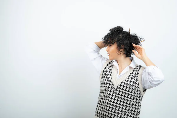 Photo of young woman with messy bun posing and standing. High quality photo