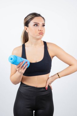 Su şişeli spor elbiseli genç bir kadın.