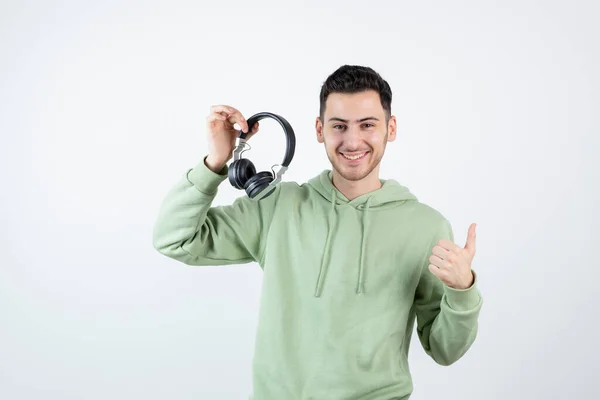 Smiling Handsome Man Holding Headphones Giving Thumbs High Quality Photo — Stock Photo, Image
