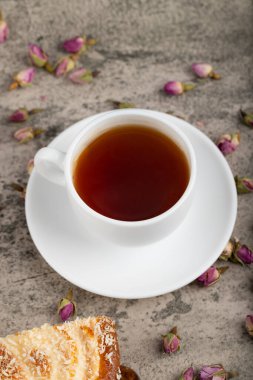 A cup of tea with dried flowers placed on stone table. High quality photo