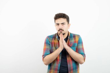 Kareli tişörtlü, çenesinin yanında el ele tutuşan yakışıklı bir adam resmi. Yüksek kalite fotoğraf