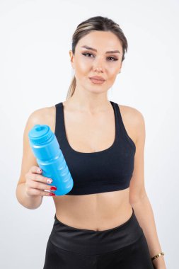 Bir şişe suyu olan genç bir kadın.