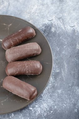Mermer zemine yerleştirilmiş lezzetli çikolatalardan oluşan siyah bir tabak. Yüksek kalite fotoğraf