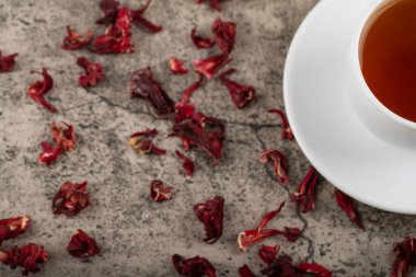 A cup of tea with dried flowers placed on stone table. High quality photo