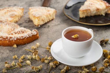 A cup of tea with dried flowers placed on stone table. High quality photo
