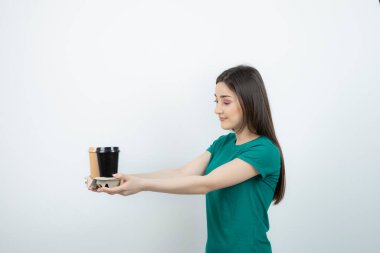 Mavi tişörtlü güzel bir kadının kahve fincanı sunduğu fotoğraf. Yüksek kalite fotoğraf