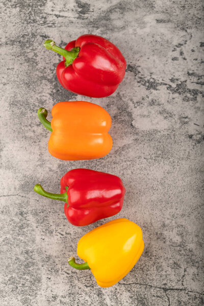 Set of healthy ripe bell peppers on stone background. High quality photo