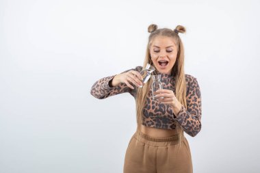 Ayakta duran ve cam şişeler tutan genç bir kadının portresi. Yüksek kalite fotoğraf