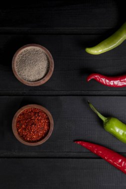 Kırmızı ve yeşil acılı biberler ahşap bir kasede baharatlı. Yüksek kalite fotoğraf