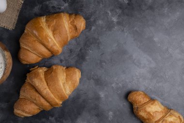 Mermer zemin üzerine yeni pişirilmiş sade kruvasanlar. Yüksek kalite fotoğraf
