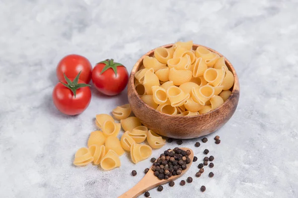 Wooden Bowl Full Uncooked Pasta Conchiglie Placed Marble Background High — Stock Photo, Image