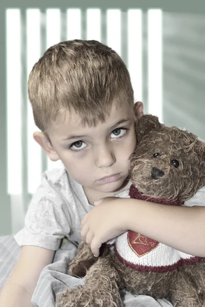 Small lonely boy with a teddy bear — Stock Photo, Image