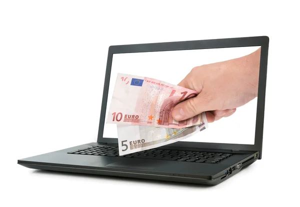 Ноутбук і руку, даючи банкноти євро — стокове фото