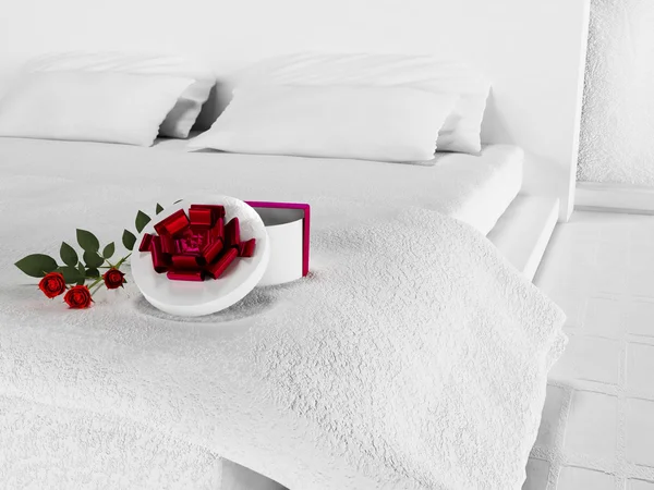 Gift with the flowers on the bed — Stock Photo, Image