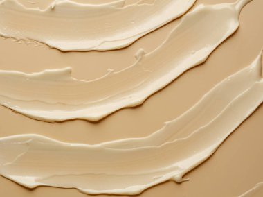 Bej arkaplanda çıplak krem dokusu.