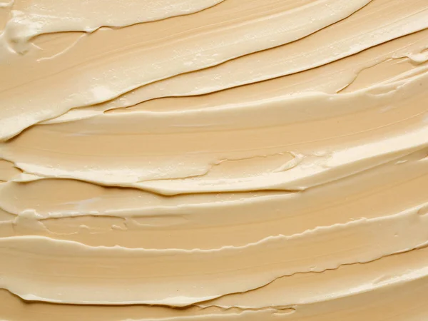 Texture di crema nuda su sfondo beige. — Foto Stock
