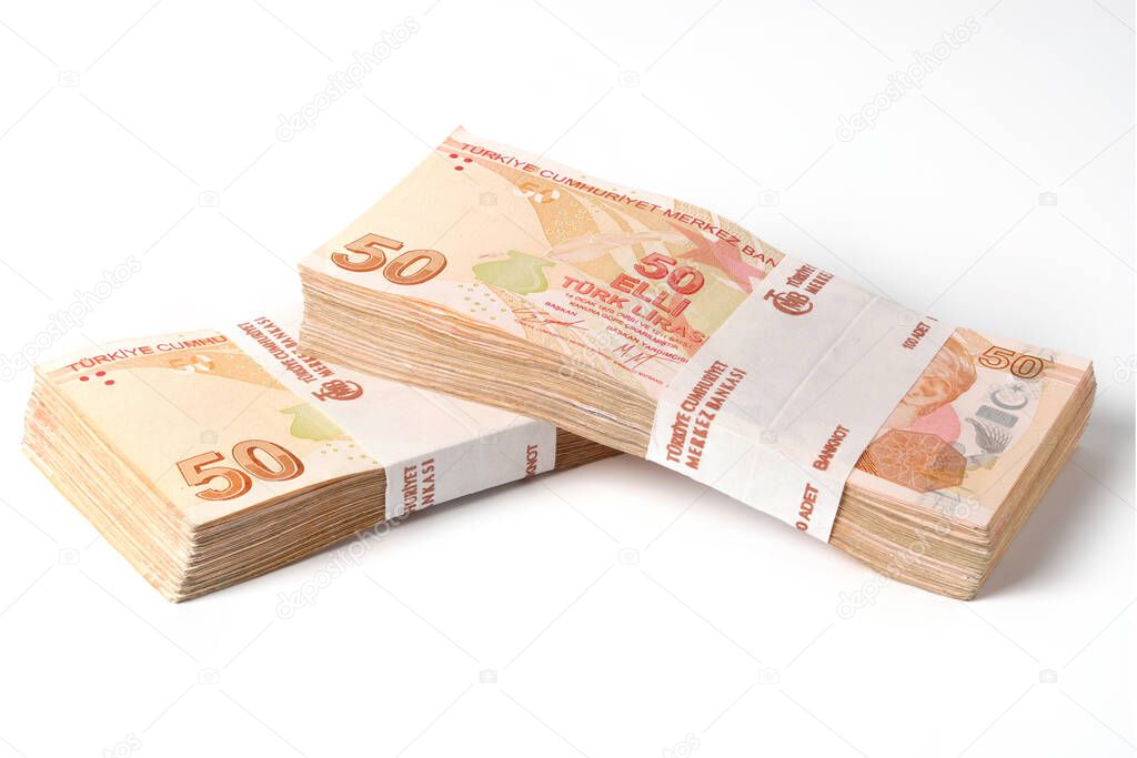 Two stacks of one hundred pieces fifty turkish lira bills isolated on white.