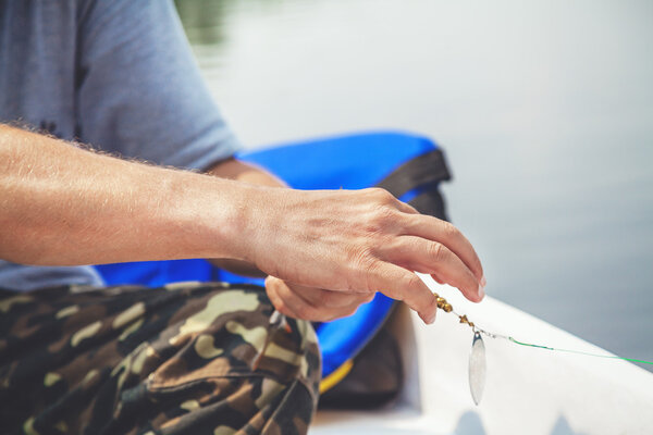 Fisherman with beard enjoys caught fish