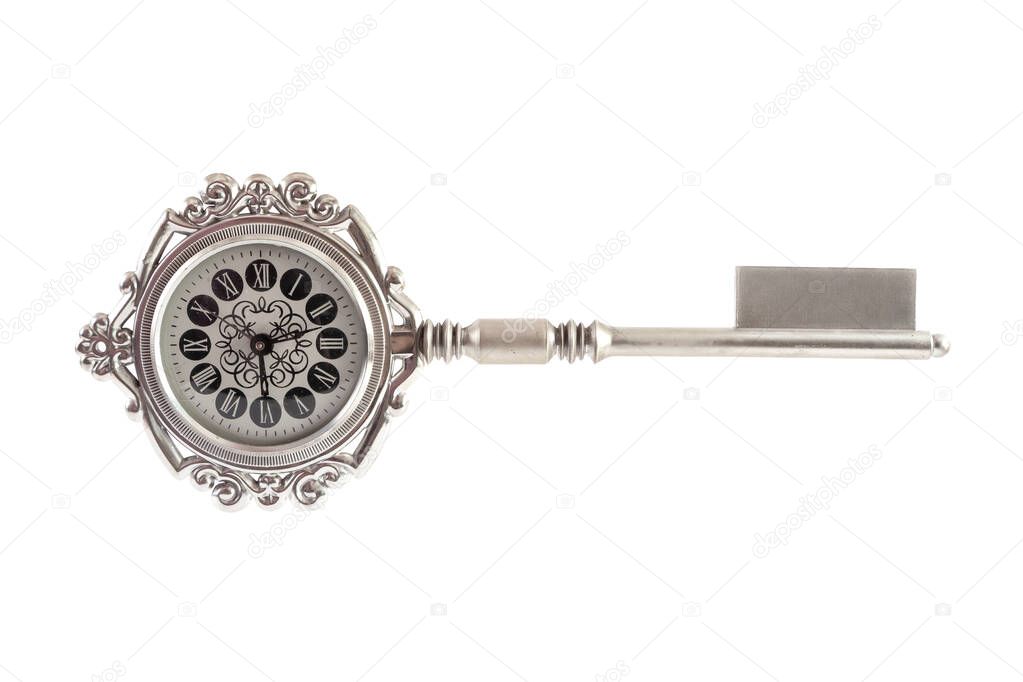 Big gift key with a real clock in a round shape stands horizontally on a white backgroun