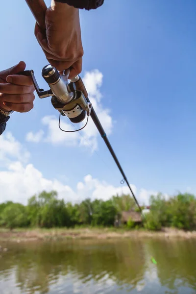 Fisherman Holding Spinning Rod Reel Background White Clouds Blue — Stock Photo, Image