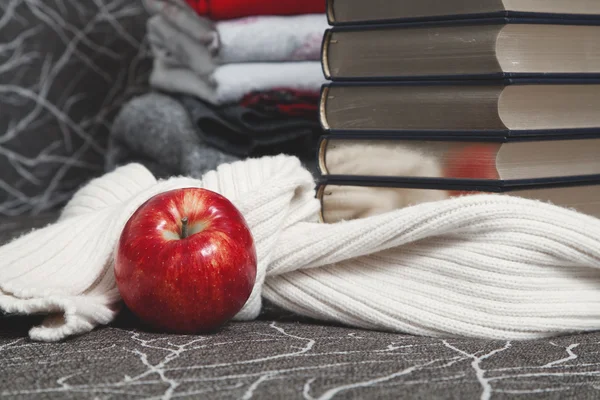 Stack of books with glossy edge and red apple — Stock Photo, Image