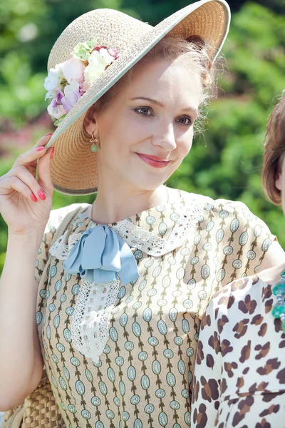 Beautiful romantic blonde girl in old straw hat — Stock Photo, Image