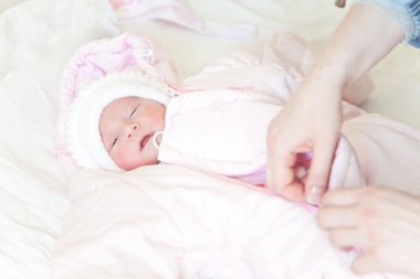 Dressing a newborn baby clipart