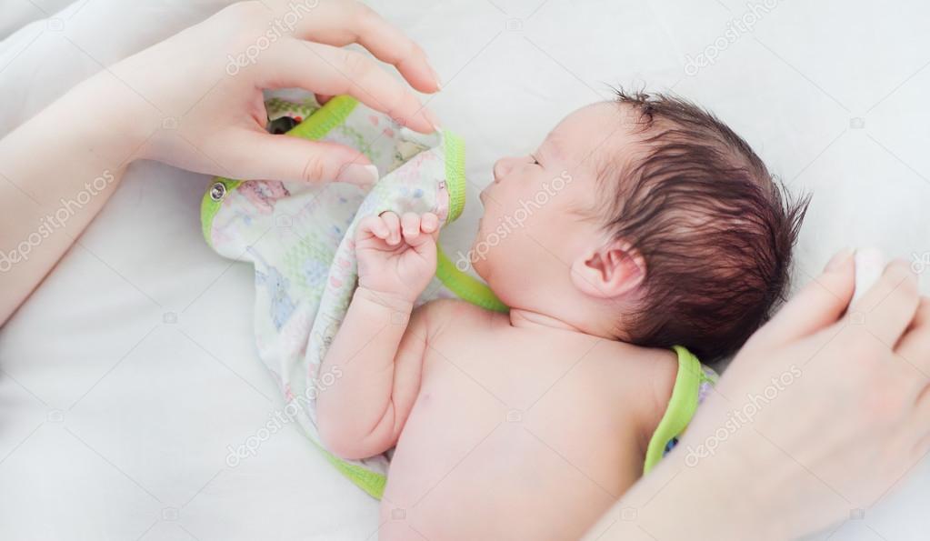 Newborn baby lying on a white diaper