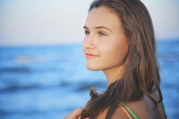 Jeune fille aux cheveux bruns sur la plage le soir d'été — Photo