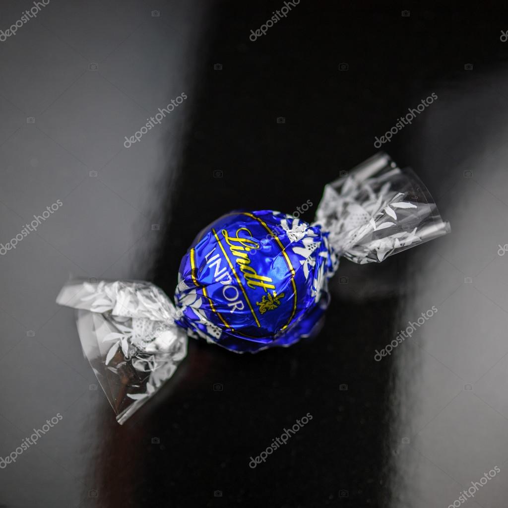 Lindt Lindor chocolate truffle on a black luxury silk background