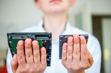 SSD vs HDD in woman's hand clipart
