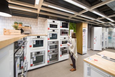 Woman buying appliances for kitchen