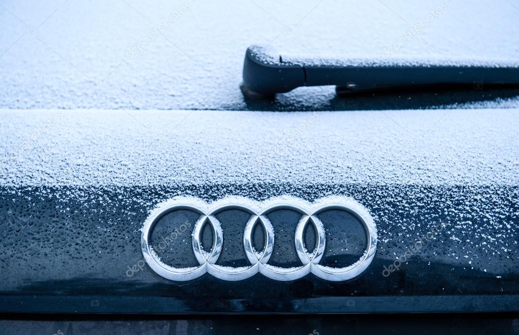 PARIS, FRANCE - JAN 20, 2016: AUDI logotype covered with snow flakes. Audi AG is a German automobile manufacturer that designs, engineers, produces, markets and distributes luxury vehicles
