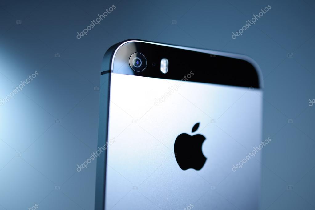 PARIS, FRANCE - APR 21, 2016: Rear view of the new Apple iPhone SE on blue background, with Apple logo and detail of the new Camera - it features updated processor, 4K rear camera, touch id, retina display