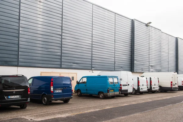 Diverse vans parked near industrial cargo dispatch building — ストック写真