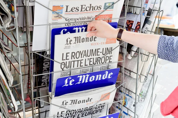 Mulher comprando jornal Le Monde com manchete chocante sobre Br — Fotografia de Stock